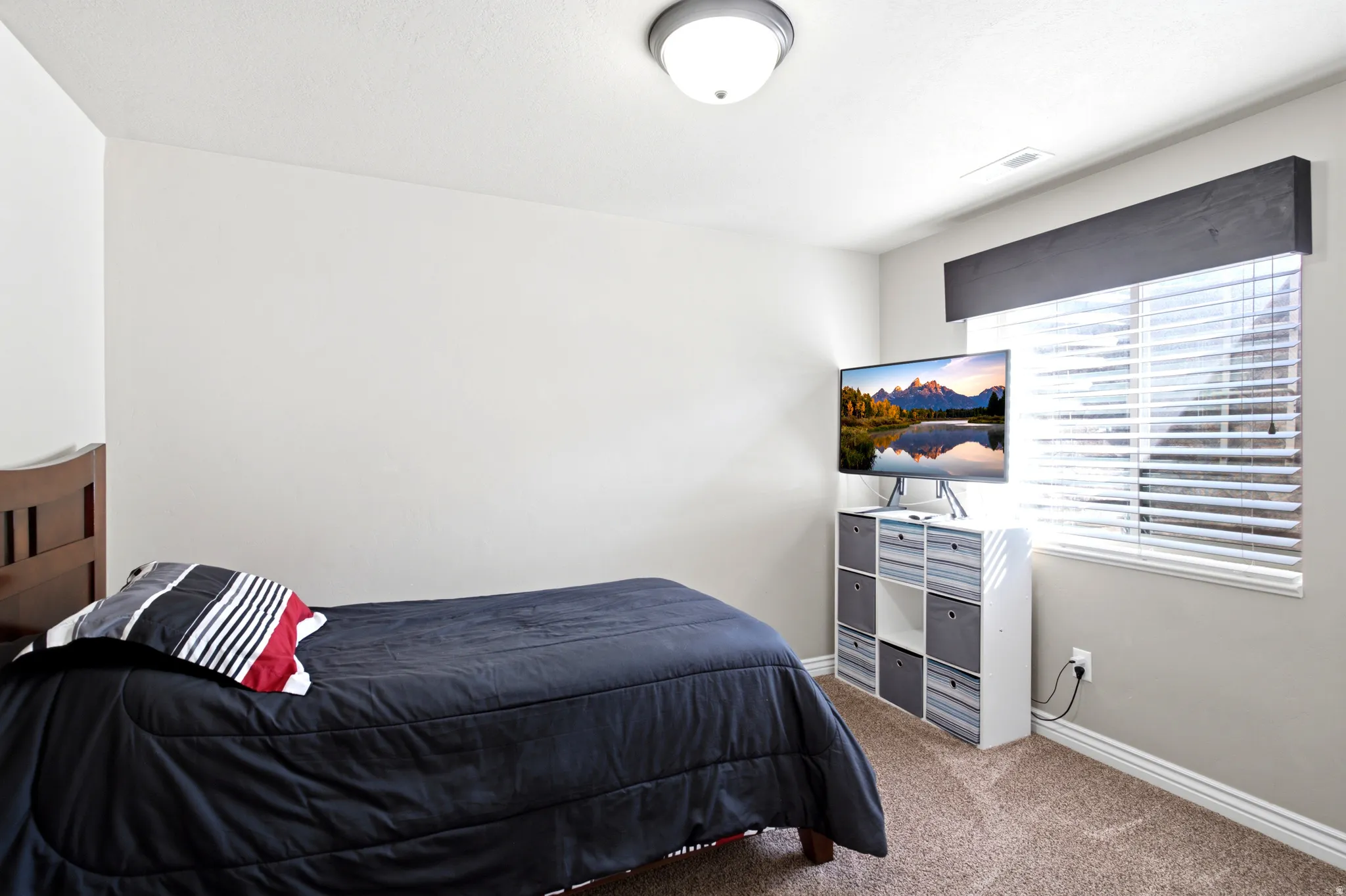 Recessed window with white blinds and dark wood valance