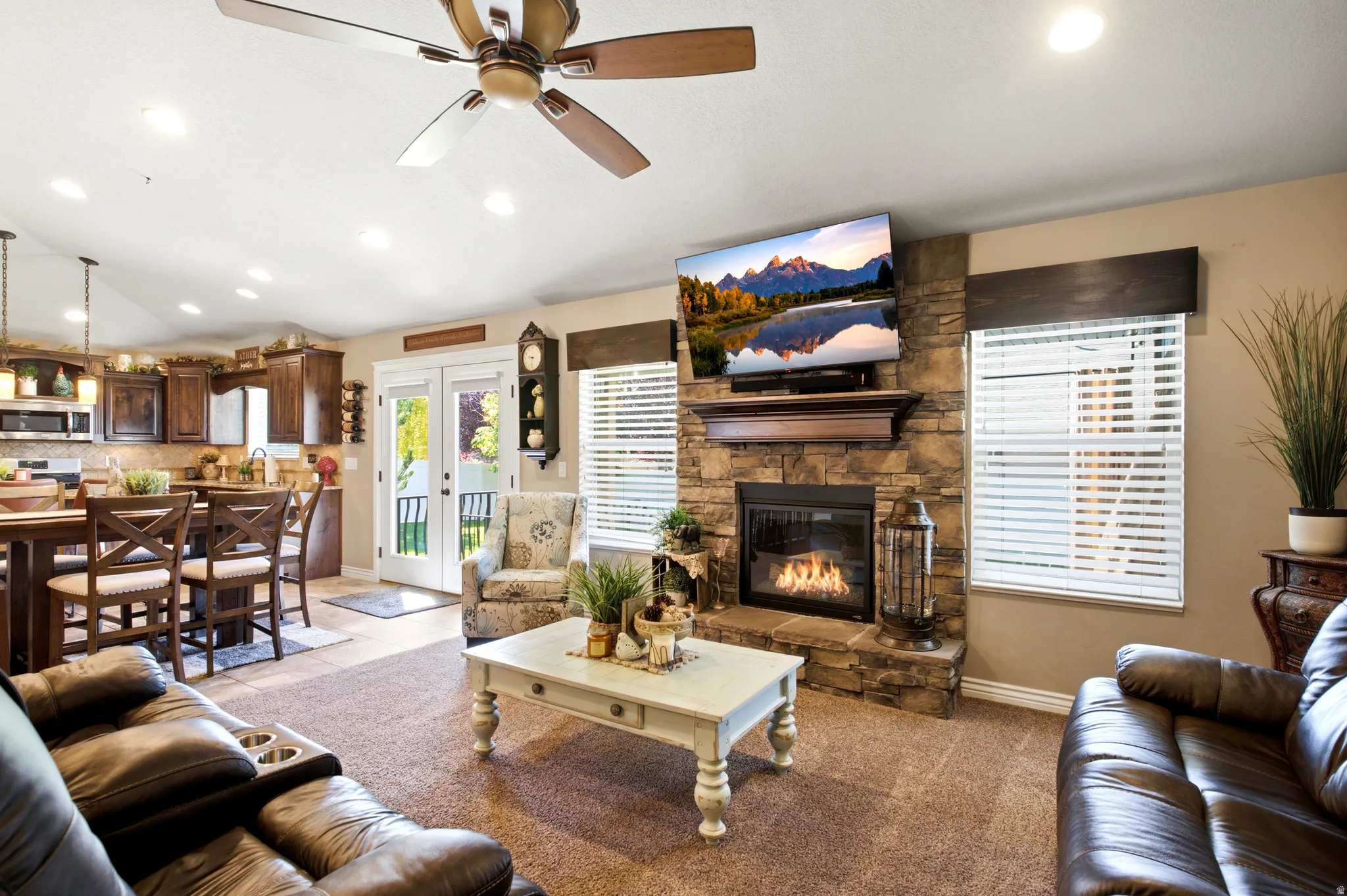 Living area with a stone-clad fireplace and wood mantle