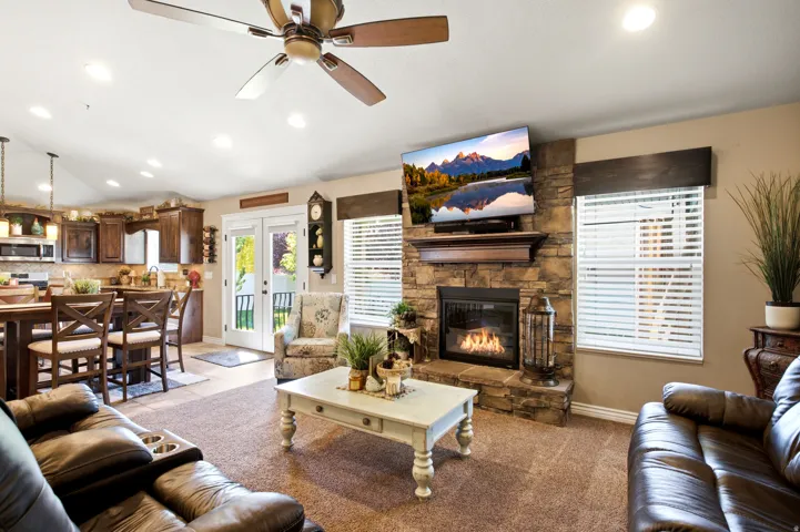 Living area with a stone-clad fireplace and wood mantle