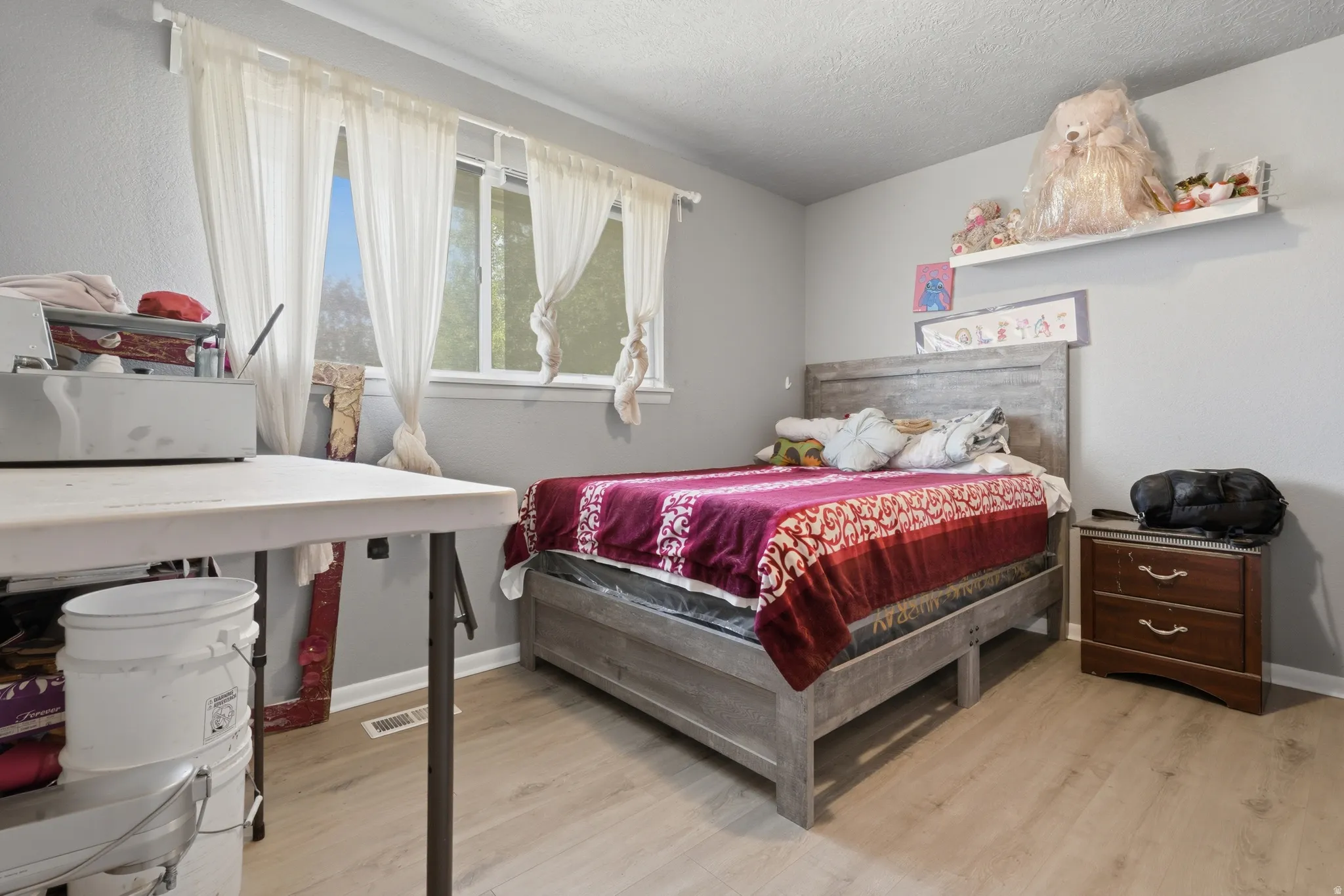 Light wood-finish flooring with gray painted walls