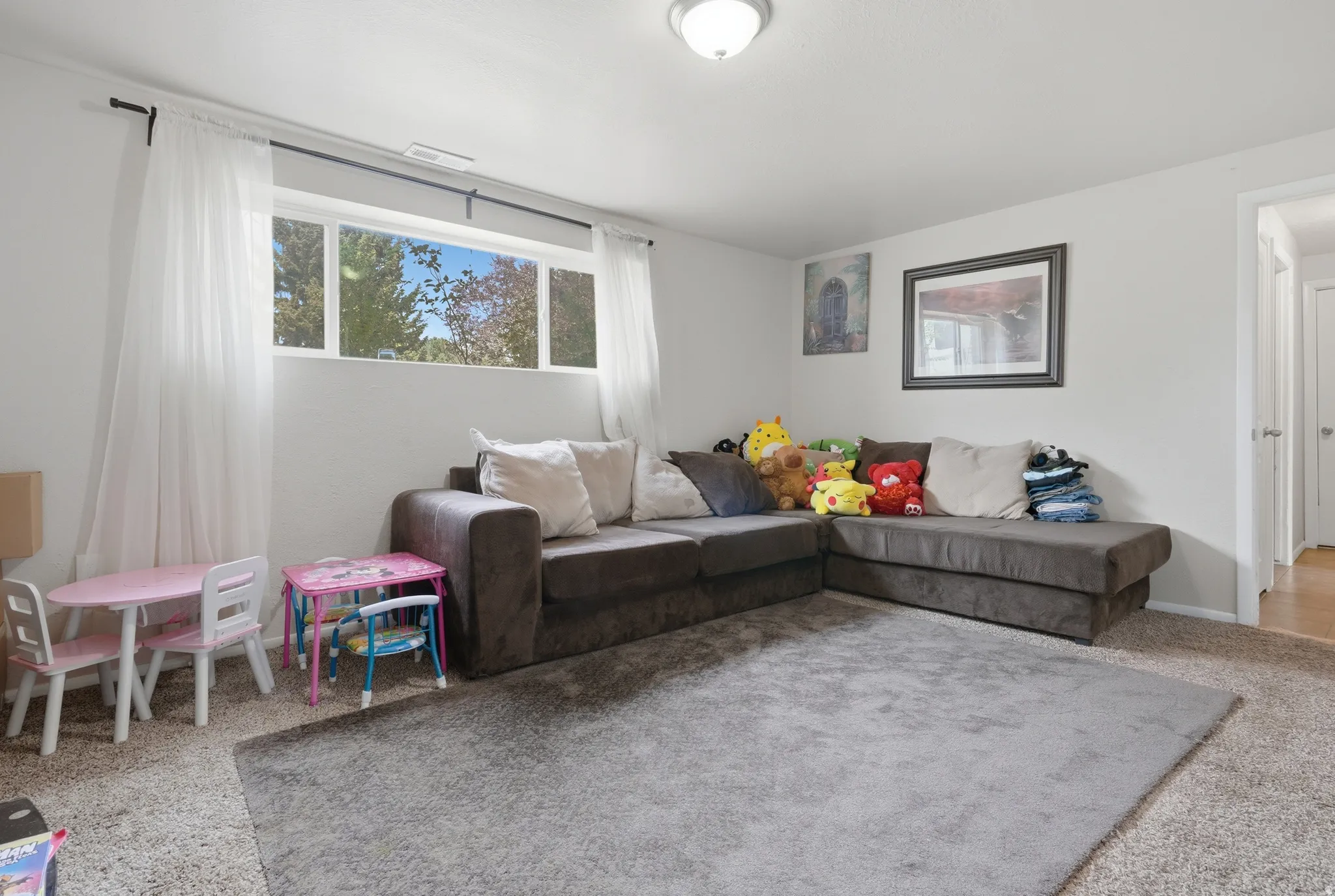 Recessed window with multiple panes, neutral wall color, and overhead flush-mount lighting