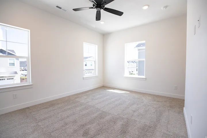 Primary bedroom with 9' ceiling and ceiling fan.