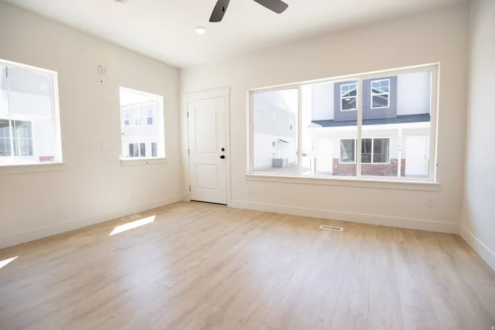 Family room with 9' ceiling and ceiling fan.
