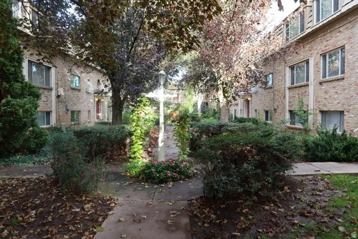 Brick exterior buildings featuring multiple windows and mature trees