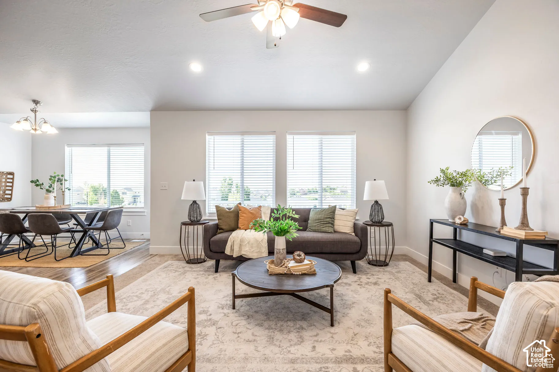 Recessed lighting, ceiling fan, multiple windows, and wood-finish flooring in an open-concept living space