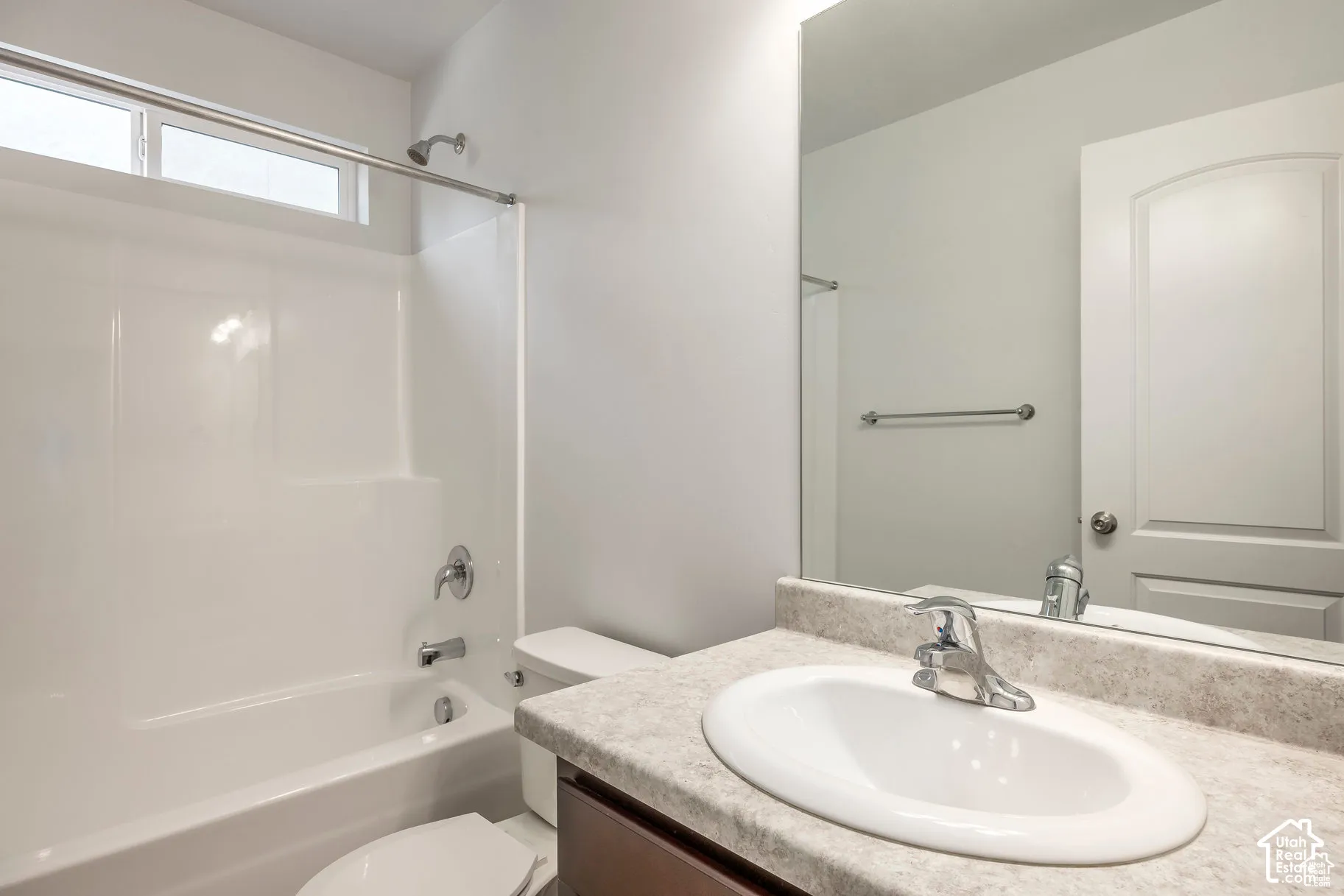 Integrated shower and tub unit with chrome fixtures and an overhead window