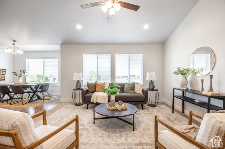 Recessed lighting, ceiling fan, multiple windows, and wood-finish flooring in an open-concept living space
