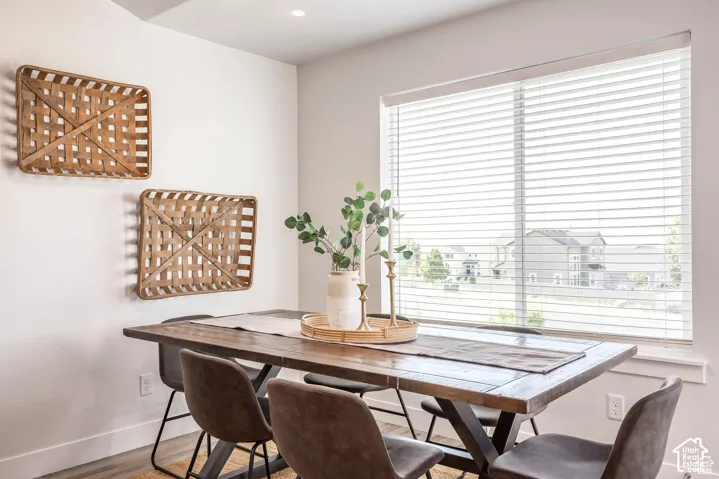 Wood-finish flooring, recessed lighting, and a large window with blinds