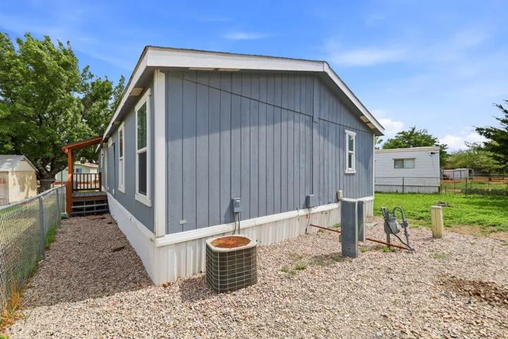 Light blue siding with white trim and a covered side entry