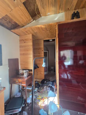 Small off grid cabin/shed with wood burning stove- owners cleaning it up!