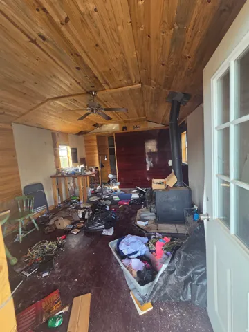 Small off grid cabin/shed with wood burning stove- owners cleaning it up!