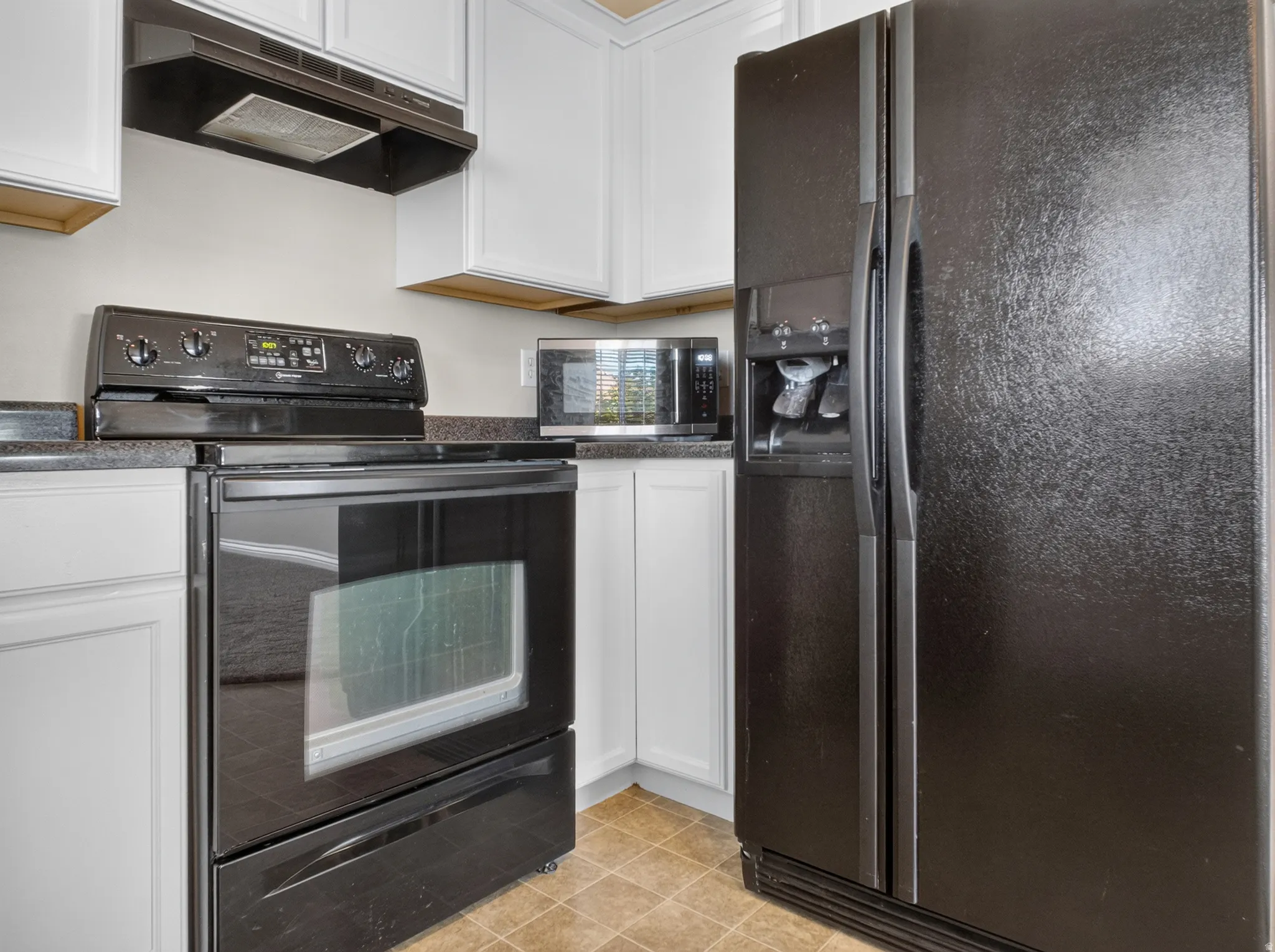 White cabinetry with dark countertops