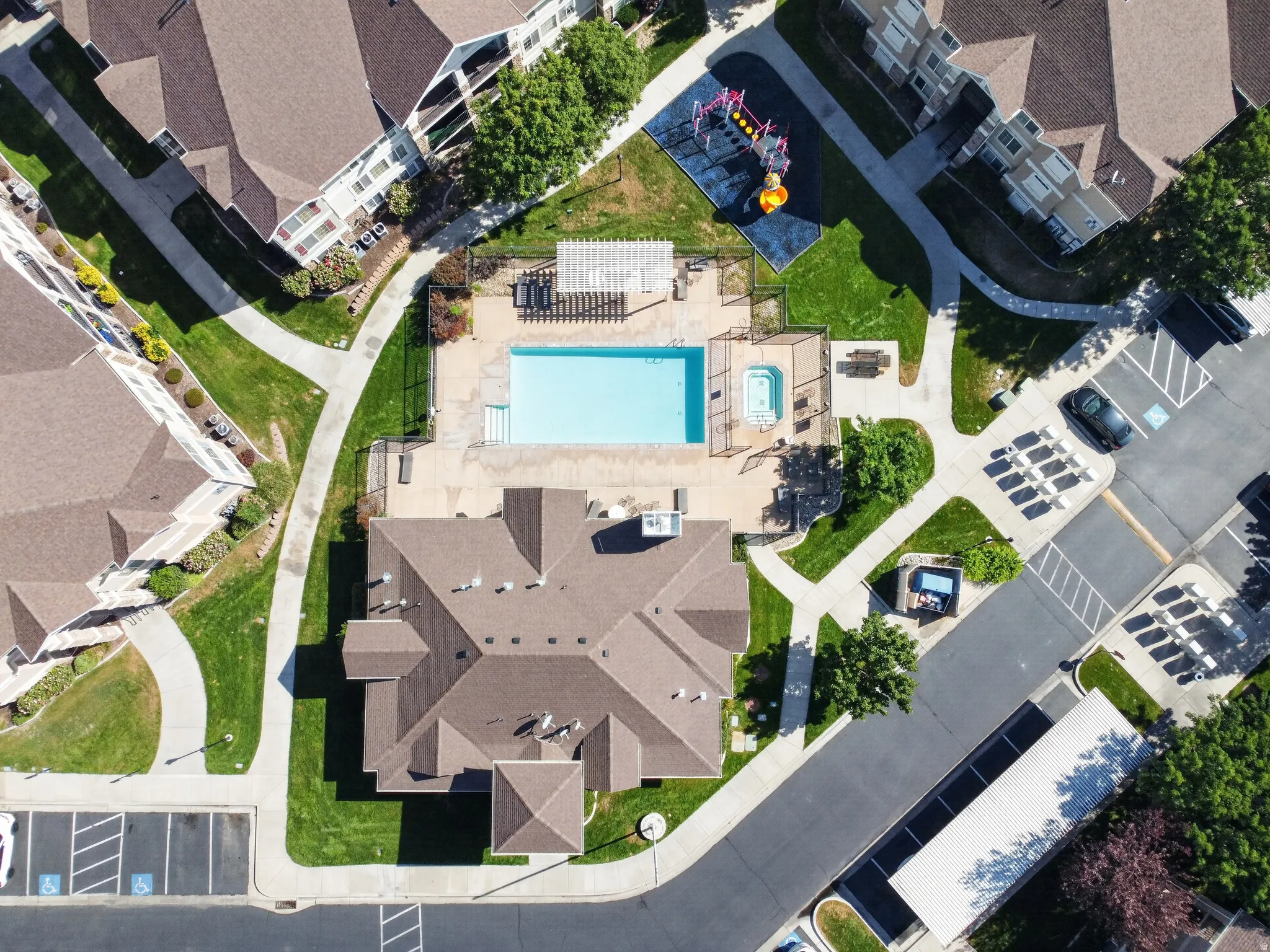 Community amenities featuring a swimming pool, hot tub, and playground
