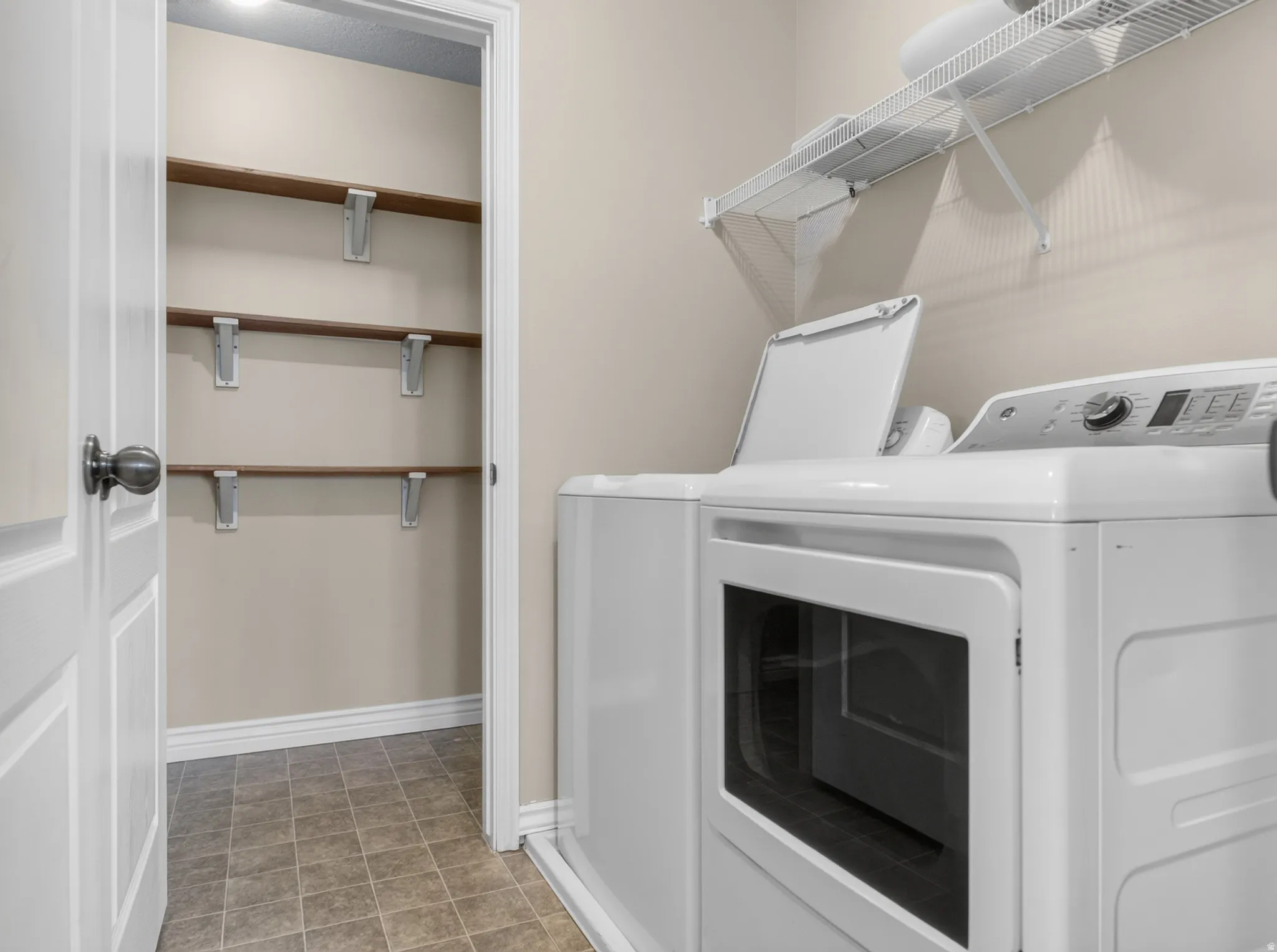 Built-in shelving, durable tile flooring, and overhead wire shelving