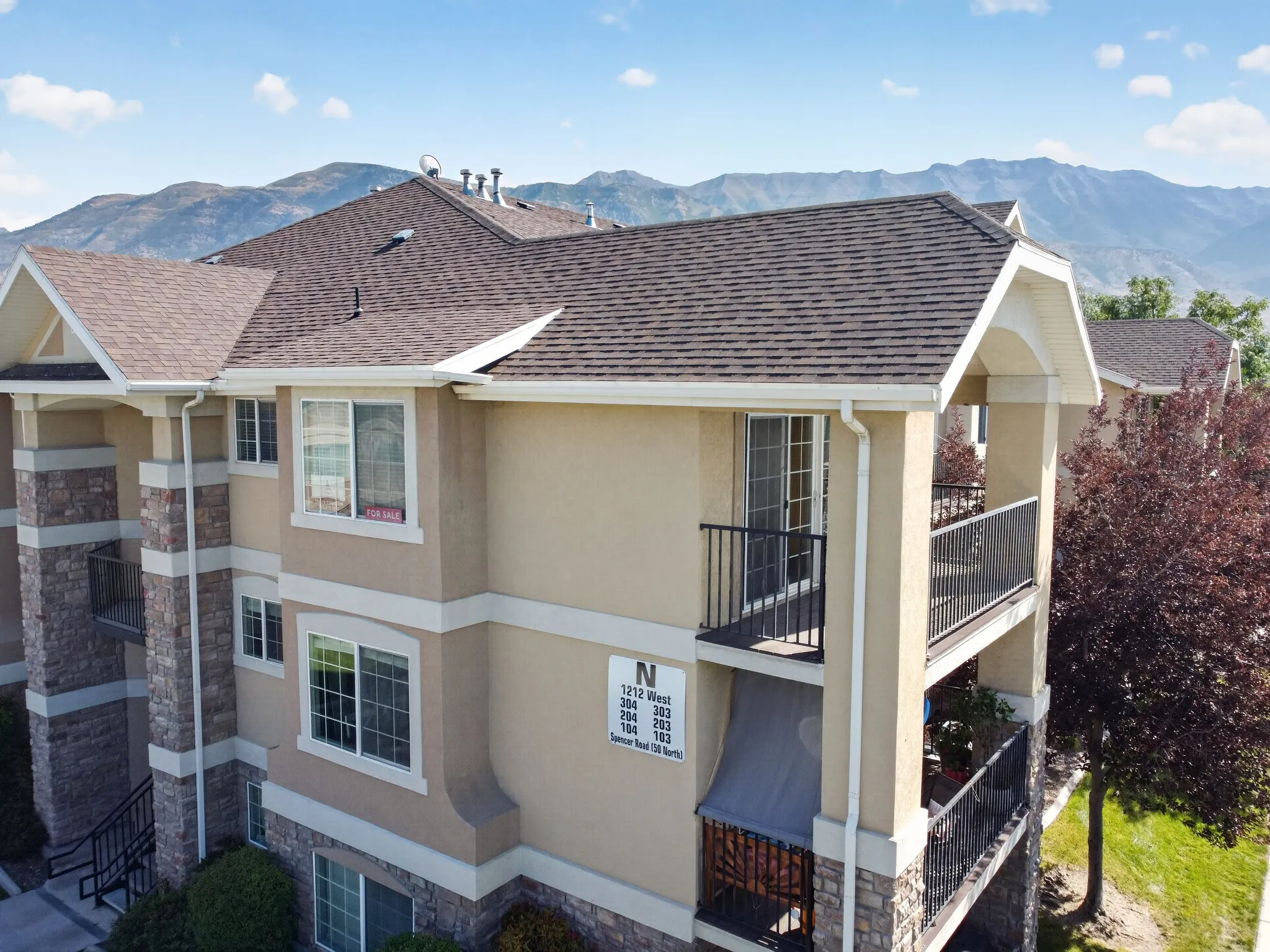 Multi-story exterior with a combination of stucco and stone veneer finishes