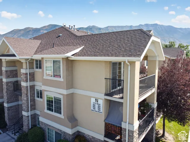 Multi-story exterior with a combination of stucco and stone veneer finishes