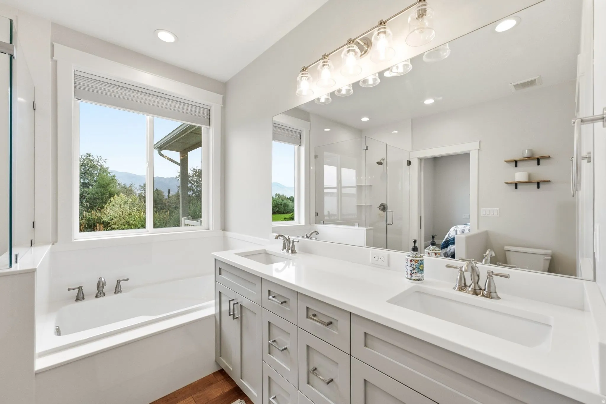 Dual vanity with undermount sinks, light gray cabinetry, and brushed nickel hardware