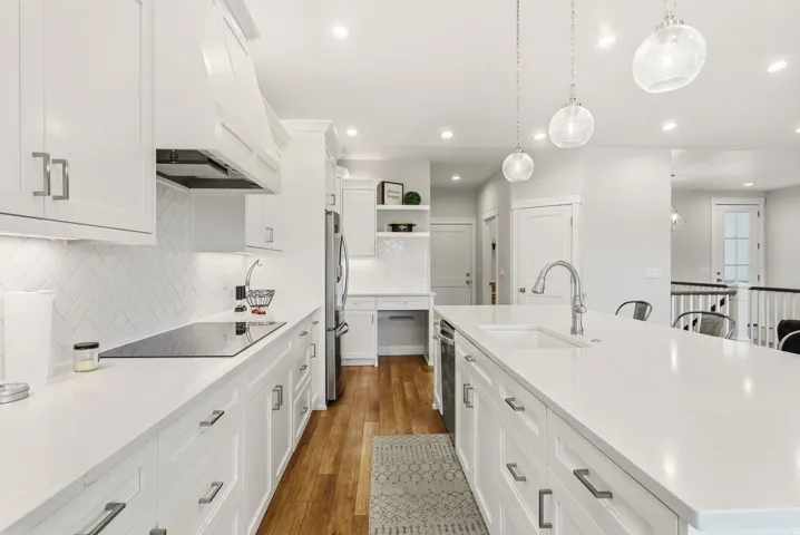 White shaker-style cabinetry with brushed nickel hardware