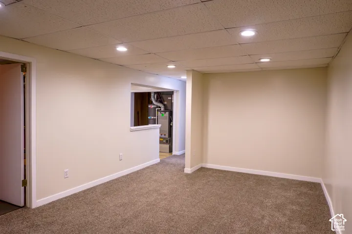 Carpeted flooring with recessed lighting and a drop ceiling