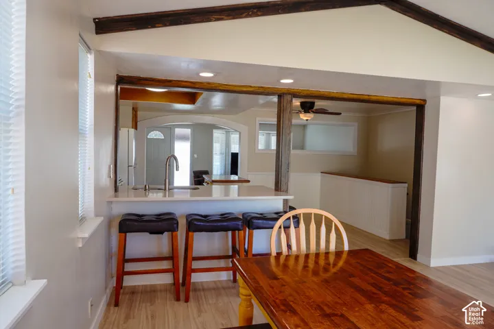 Kitchen island with a light-toned countertop and stainless steel faucet