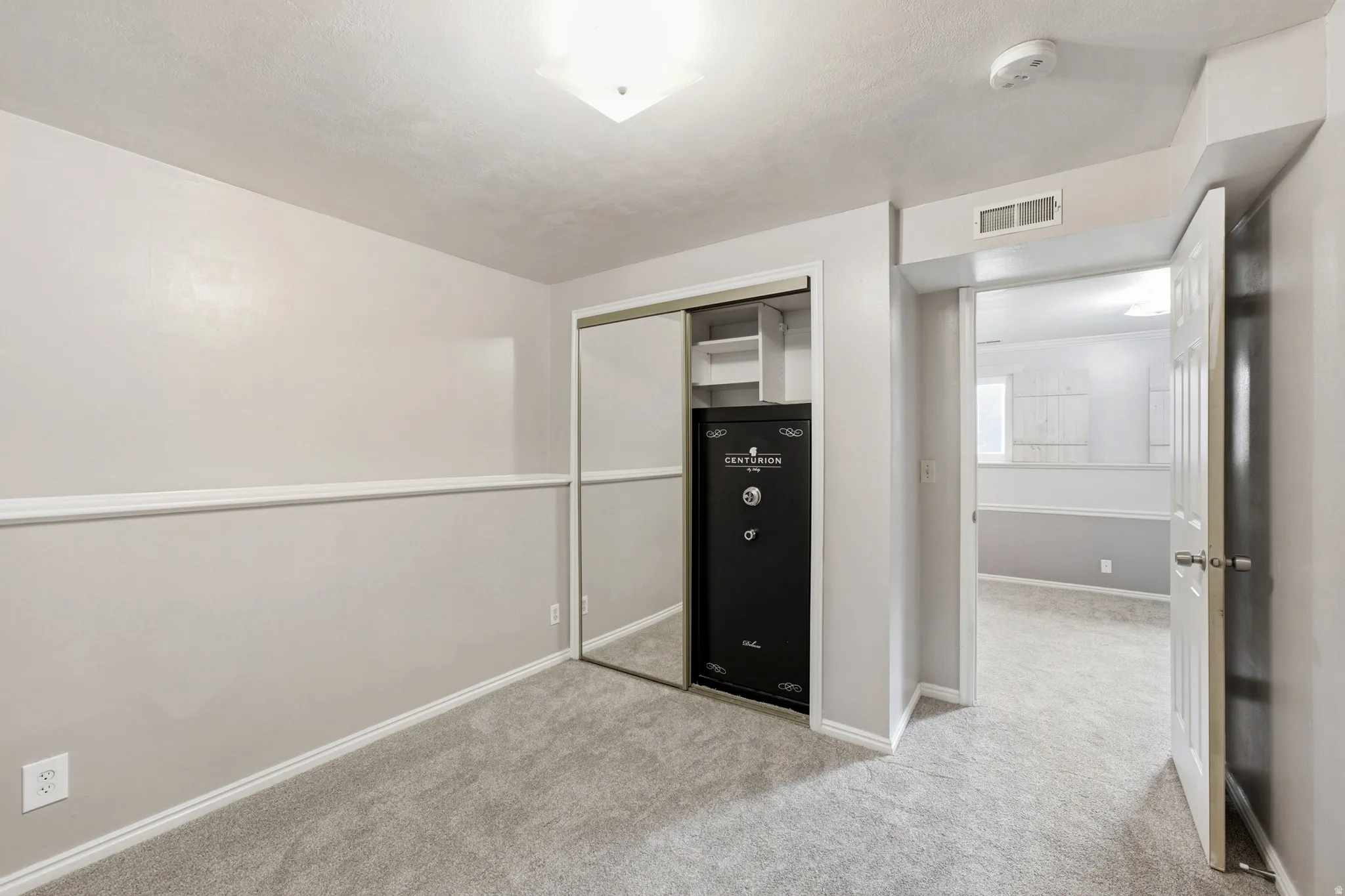 Neutral-toned carpet flooring with white trim detailing