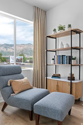 Wood-finish flooring with a large window and full-height drapery