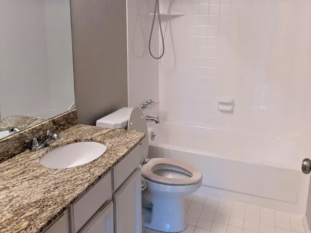 Master Bathroom. Vanity with granite-style countertop, integrated sink, and white cabinetry
