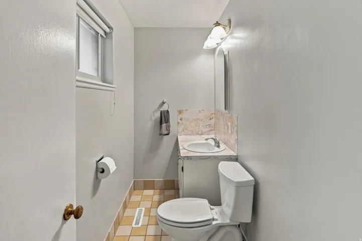 Master Bathroom with vanity,  wall-mounted mirror, and decorative light fixture