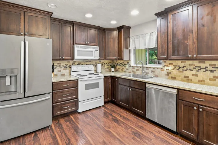 Kitchen featuring dark wood-finish cabinetry