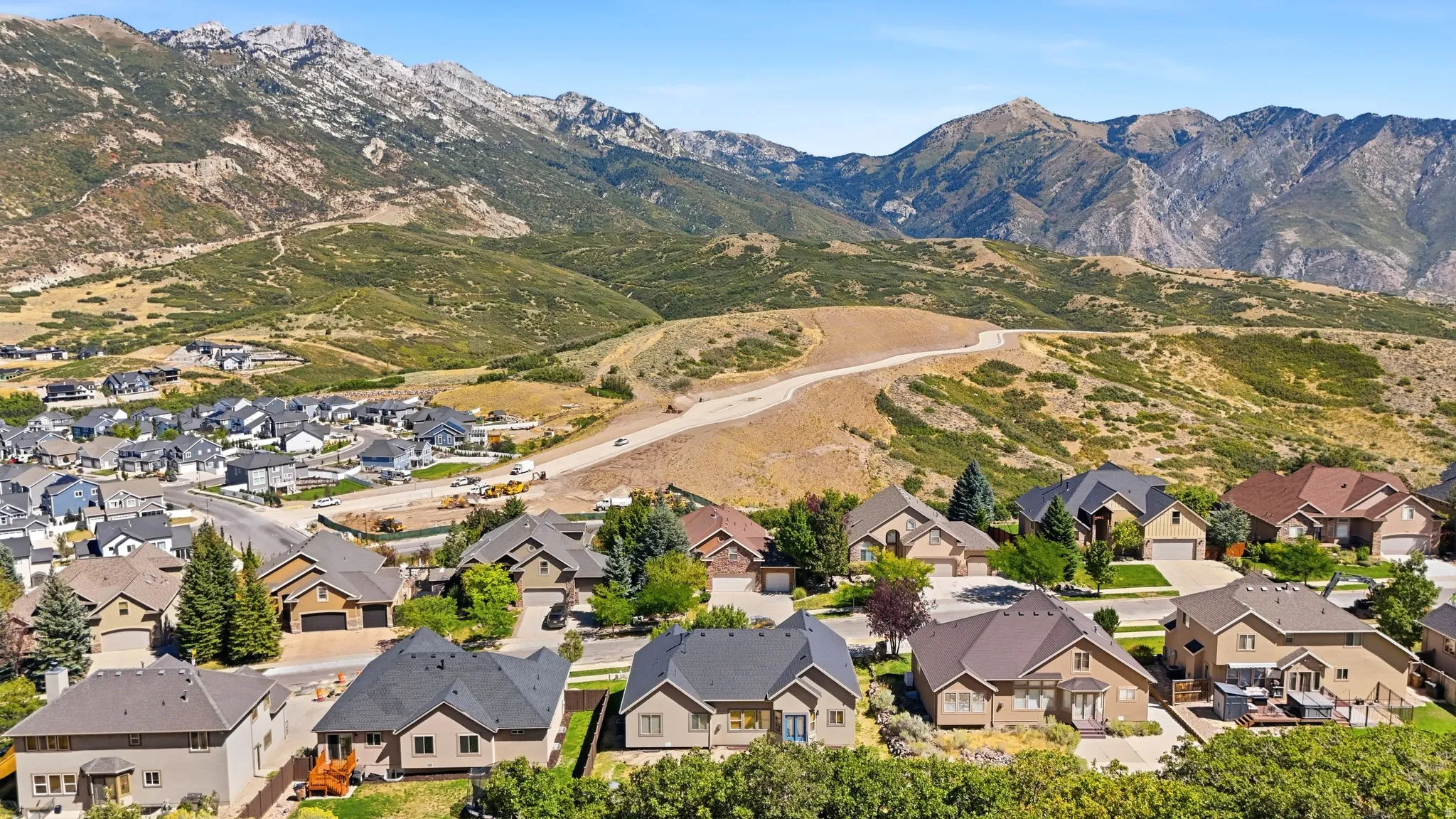 Residential neighborhood with varied architectural styles and a prominent mountain backdrop