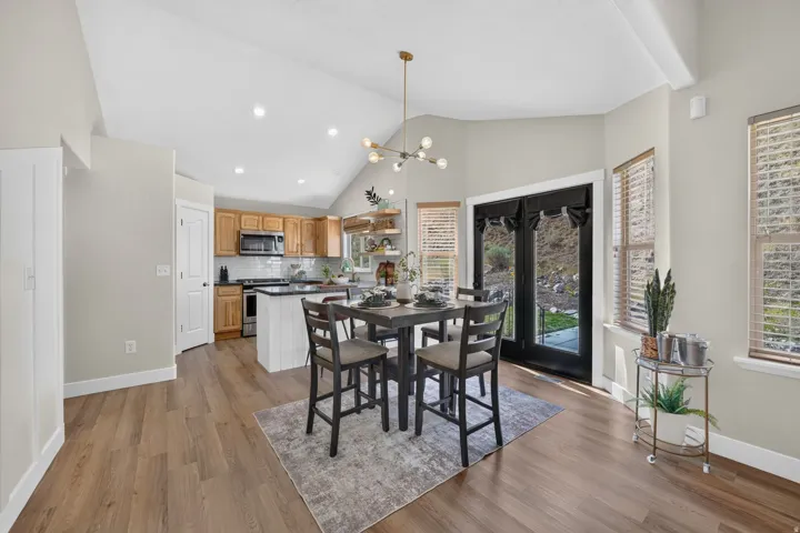 Vaulted ceiling with recessed lighting and a contemporary chandelier
