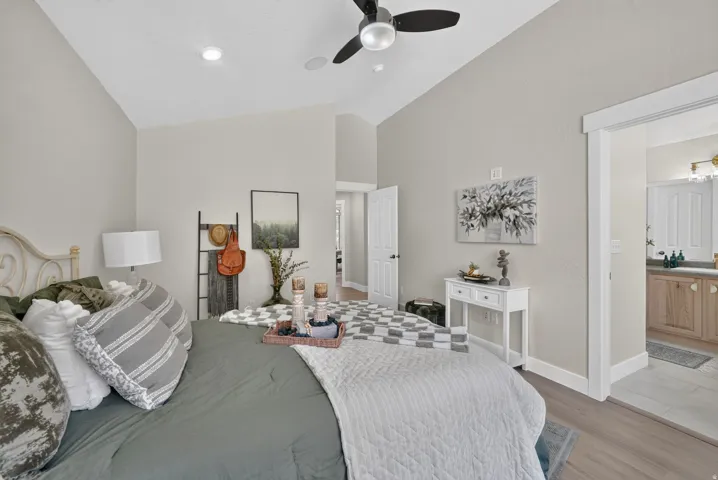 Vaulted ceiling, ceiling fan, recessed lighting, wood-finish flooring, white trim