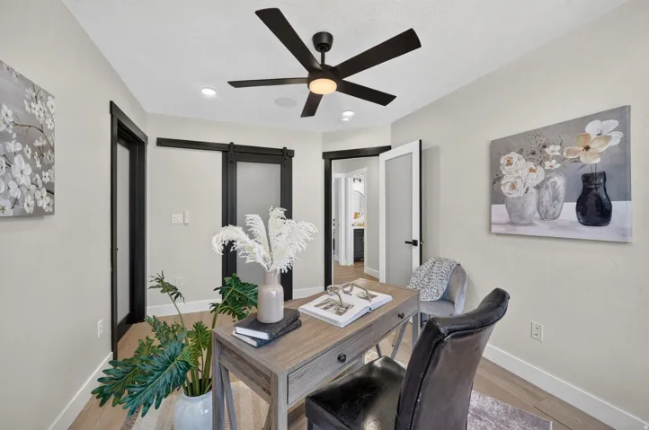 Wood-finish flooring, recessed lighting, and a ceiling fan with integrated lighting