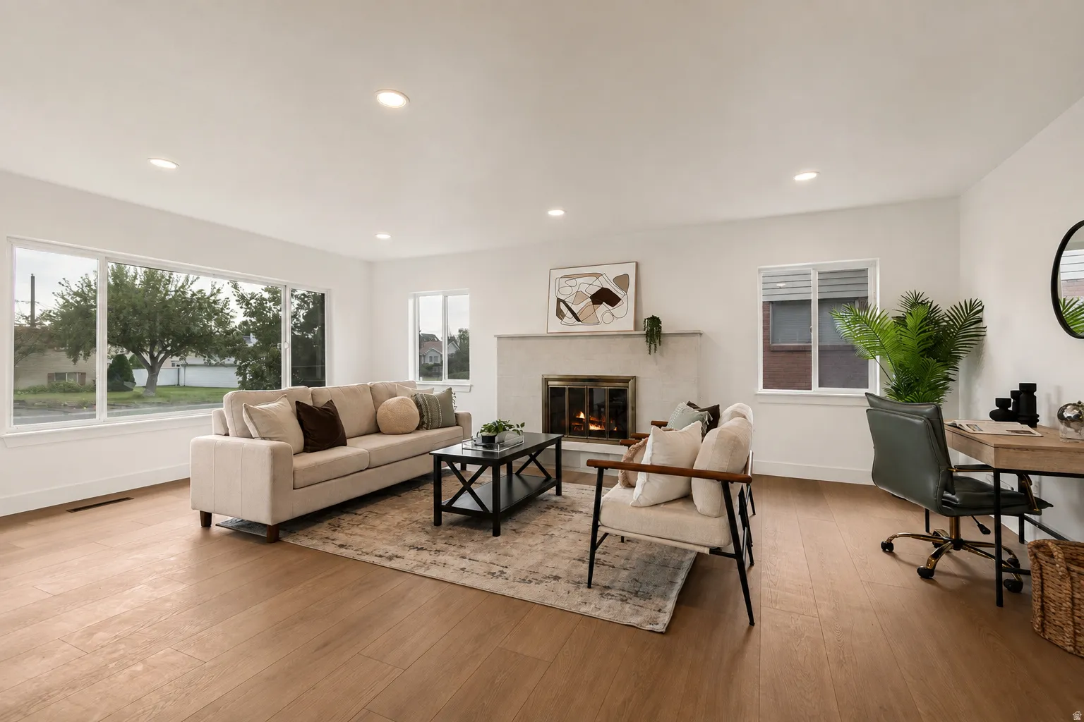 Light wood-finish flooring, recessed lighting, and a neutral color palette