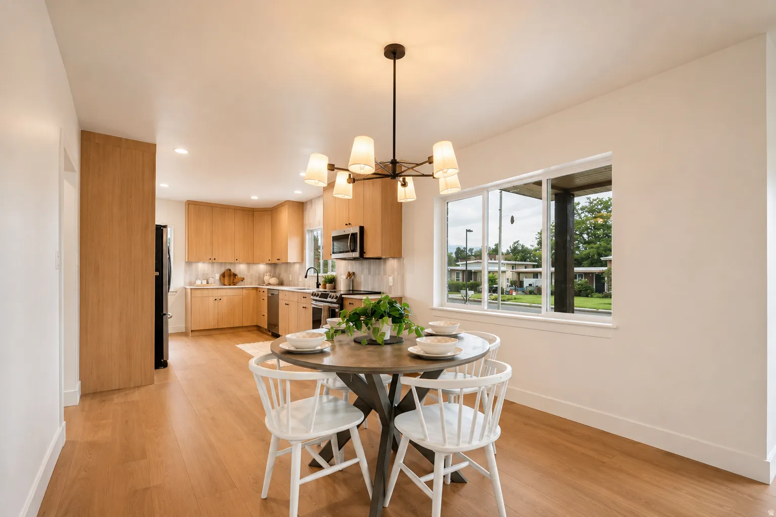Kitchen with wood-finish cabinetry, stainless steel appliances, and recessed lighting