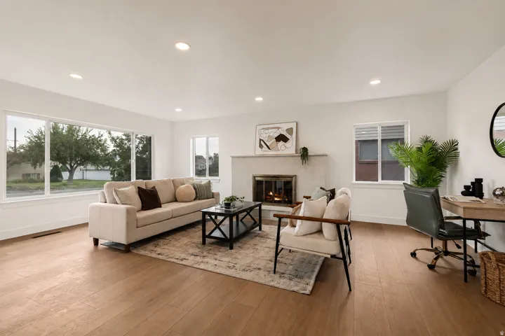 Light wood-finish flooring, recessed lighting, and a neutral color palette