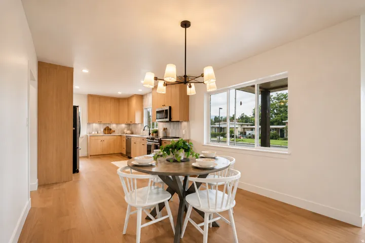 Kitchen with wood-finish cabinetry, stainless steel appliances, and recessed lighting