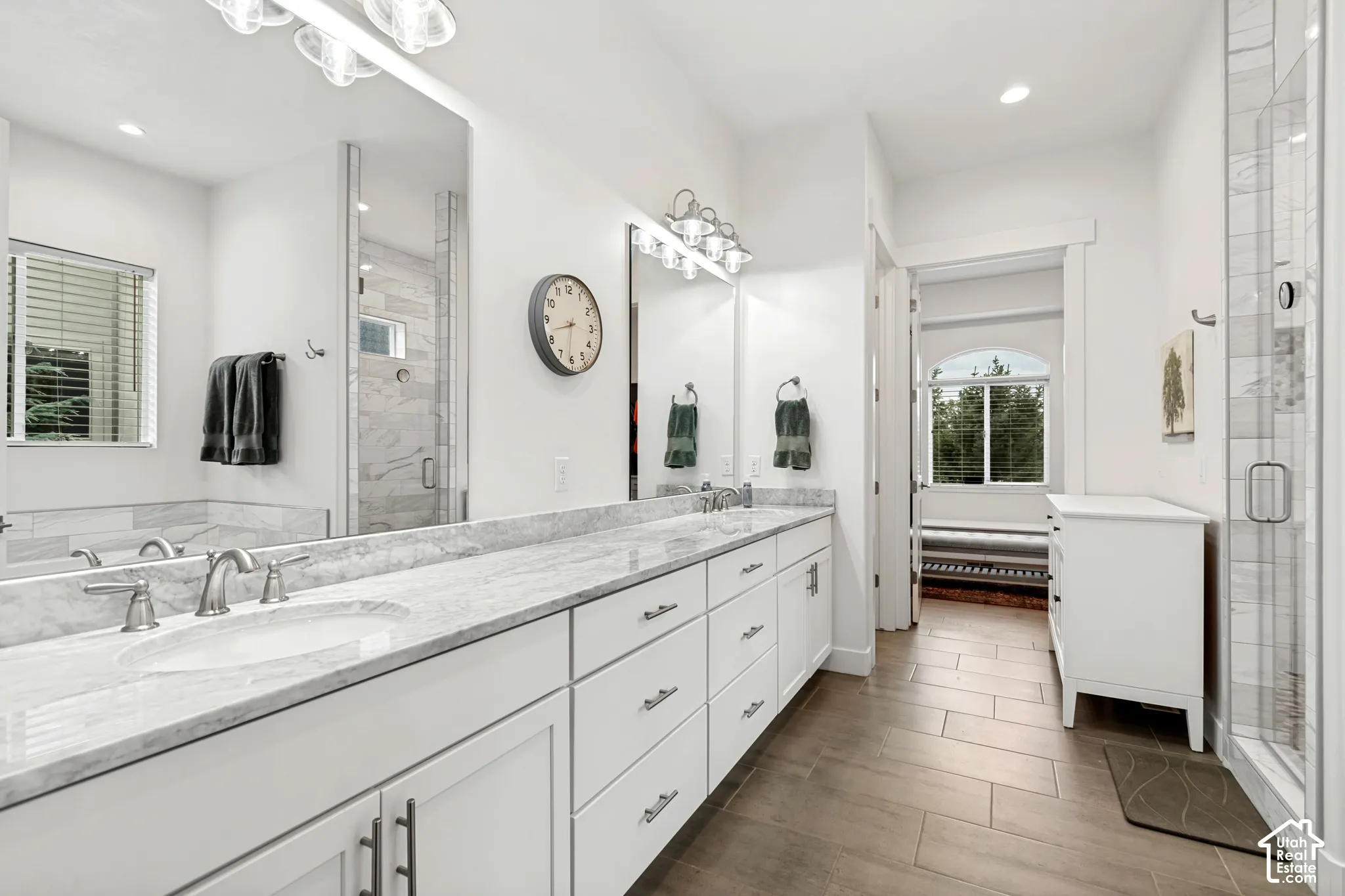 Double vanity with undermount sinks, marble countertops, and brushed nickel fixtures