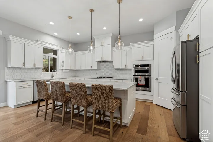 Dream kitchen w/ white cabinetry, marble Countertops  & Large Island