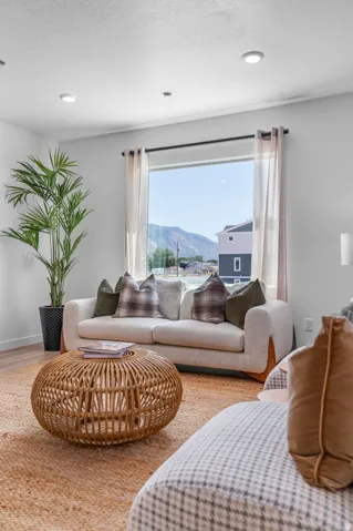 Recessed ceiling lighting illuminates a spacious room with a large window