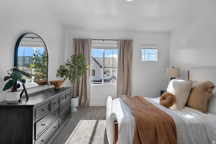 Spacious room with plush carpet flooring, two windows, and recessed ceiling lighting
