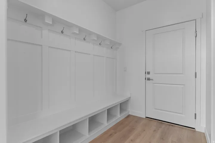 Built-in hall tree with integrated bench seating, cubby storage, and wall-mounted hooks