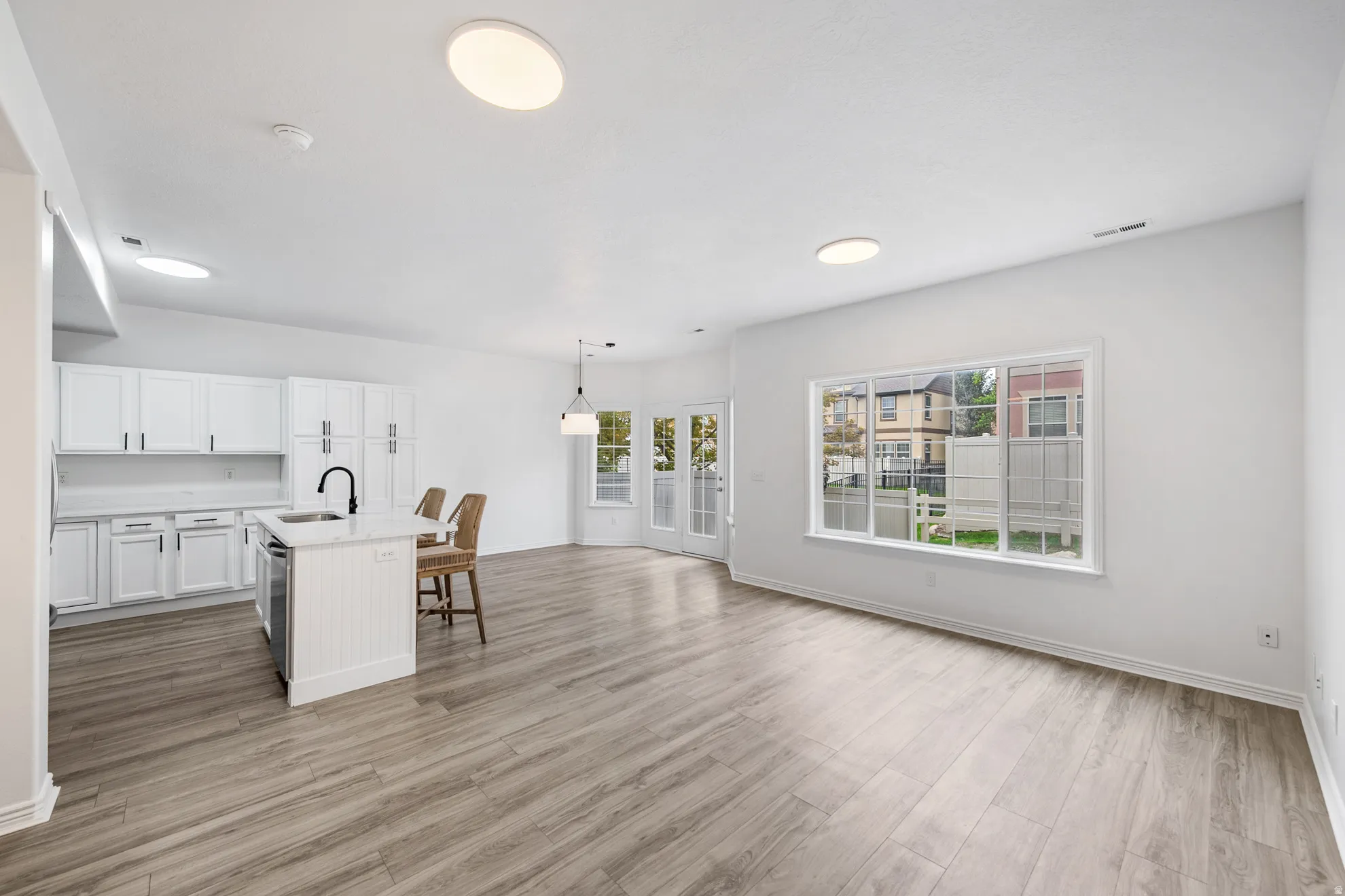 Open-concept layout with wood-finish flooring