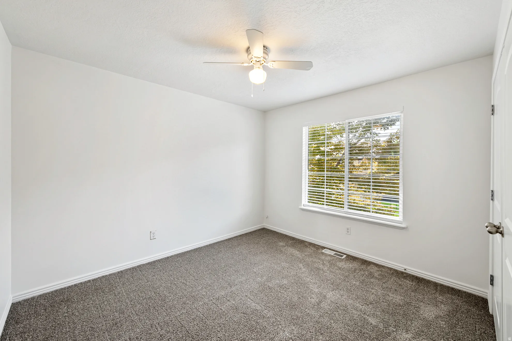 Recessed lighting, ceiling fan, carpet flooring, window with blinds, and white door with a round knob