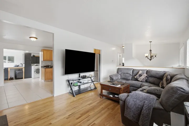 Wood-finish flooring, white walls, and a recessed ceiling light