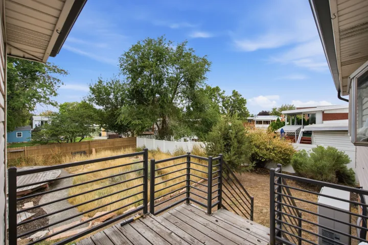 Wood-finish decking with black horizontal railing and stairs