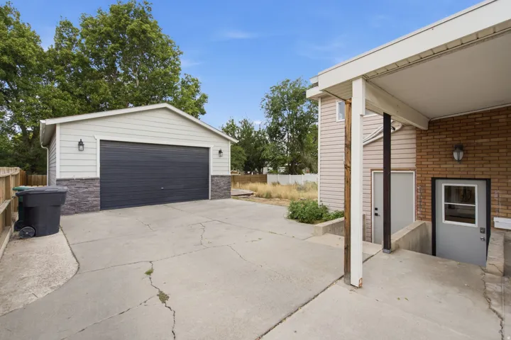 Detached two-car garage with overhead door and exterior lighting