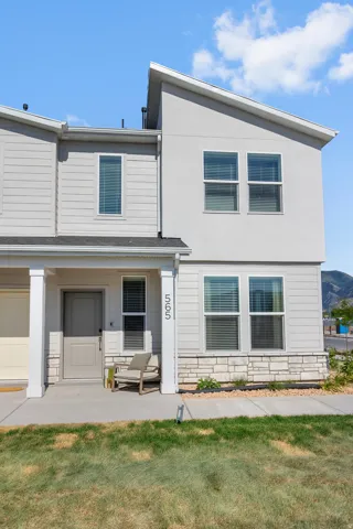 Modern exterior featuring a light gray facade with horizontal siding and stucco