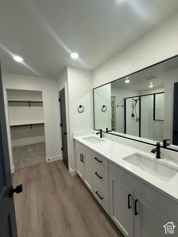 Double vanity featuring white cabinetry, quartz countertops, dual rectangular under-mount sinks, and matte black hardware