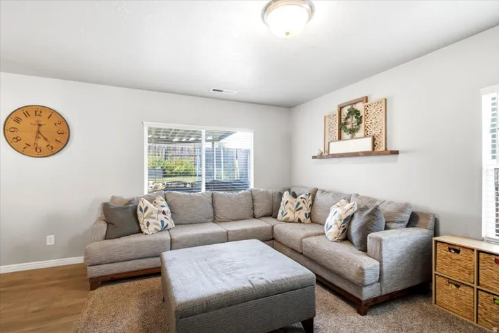 Recessed lighting, wood-finish flooring, and a sliding glass door